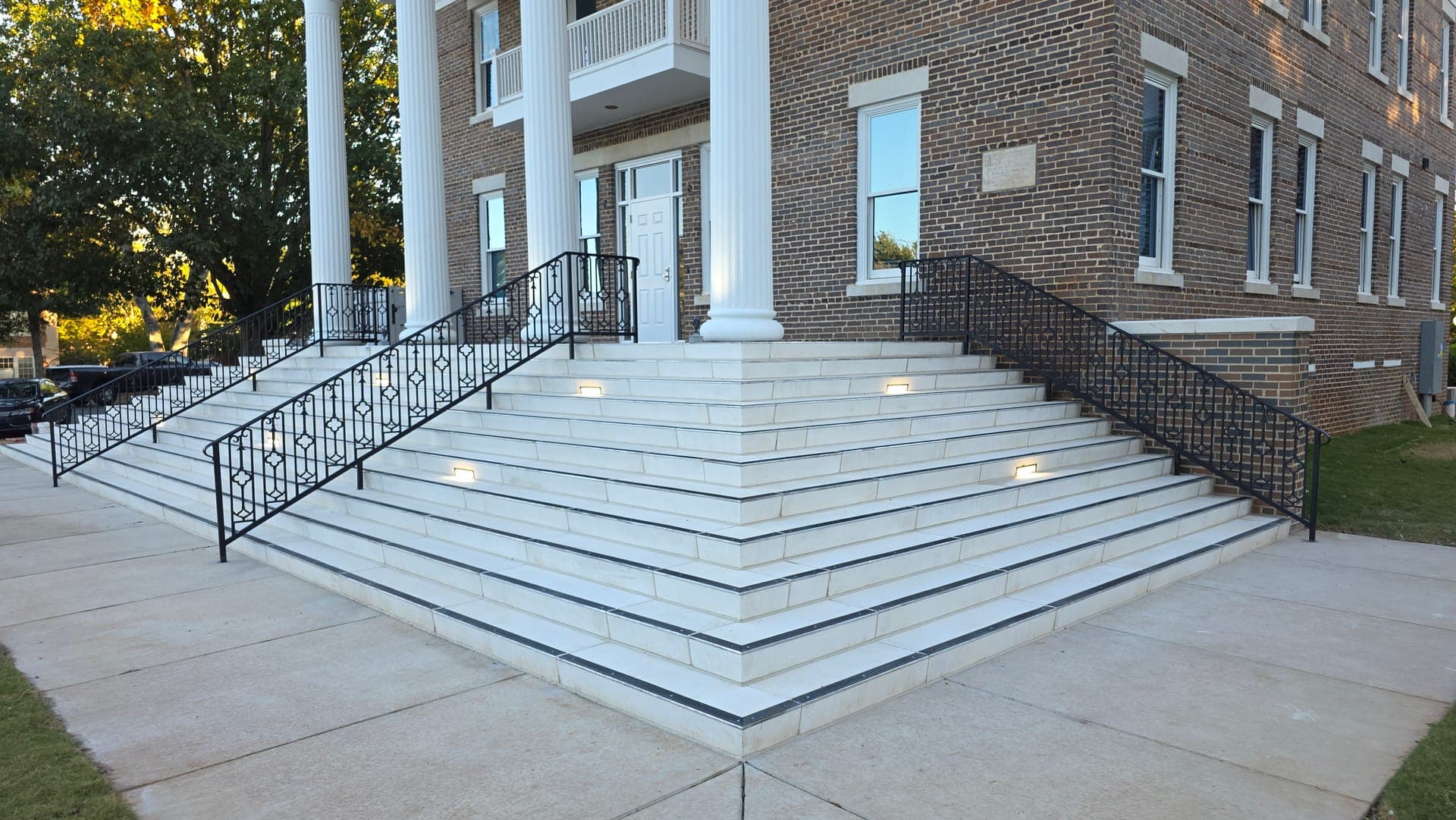 Custom metal railings installed across the entrance steps at Brown Hall, Athens State University
