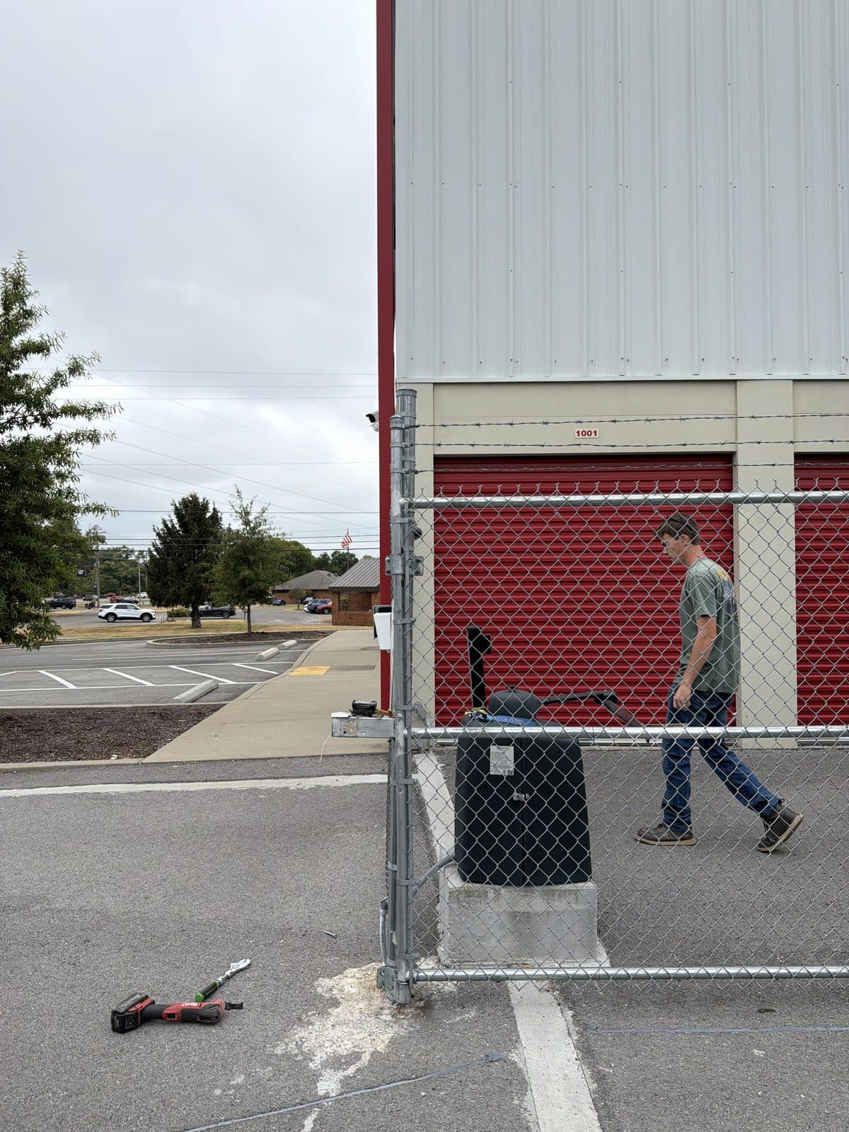 Repaired chain link fence standing straight beside the gate opener at Storage Sense, La Vergne, TN