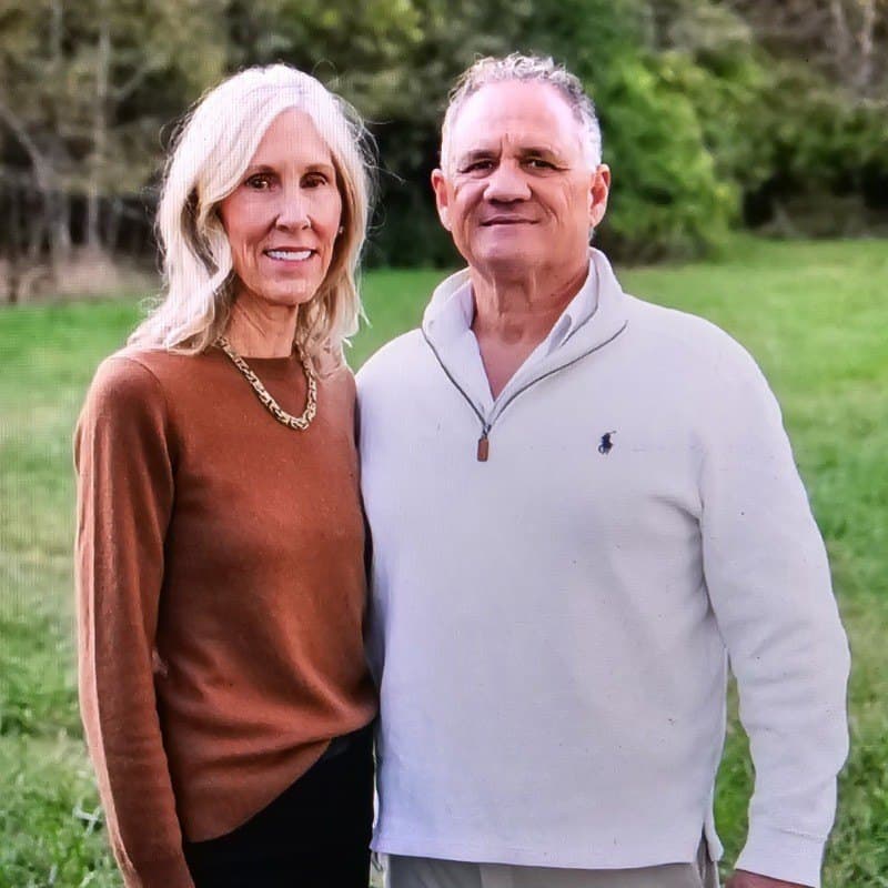 Richard Arnold, owner of 3D Custom Welding, standing in a field with his wife Dawn