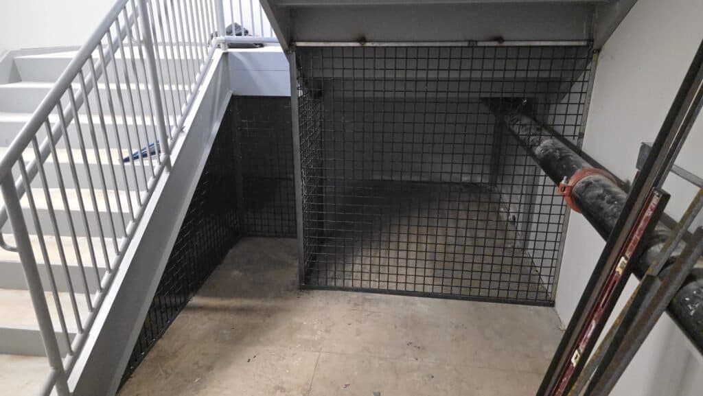 Commercial staircase with security cage